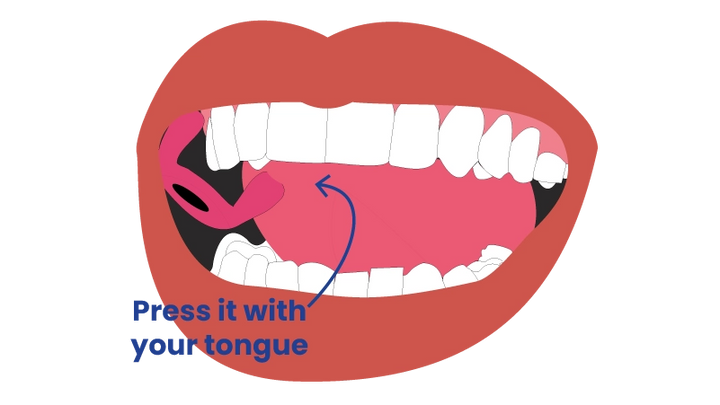 Press the tip with your tongue to pop it out.