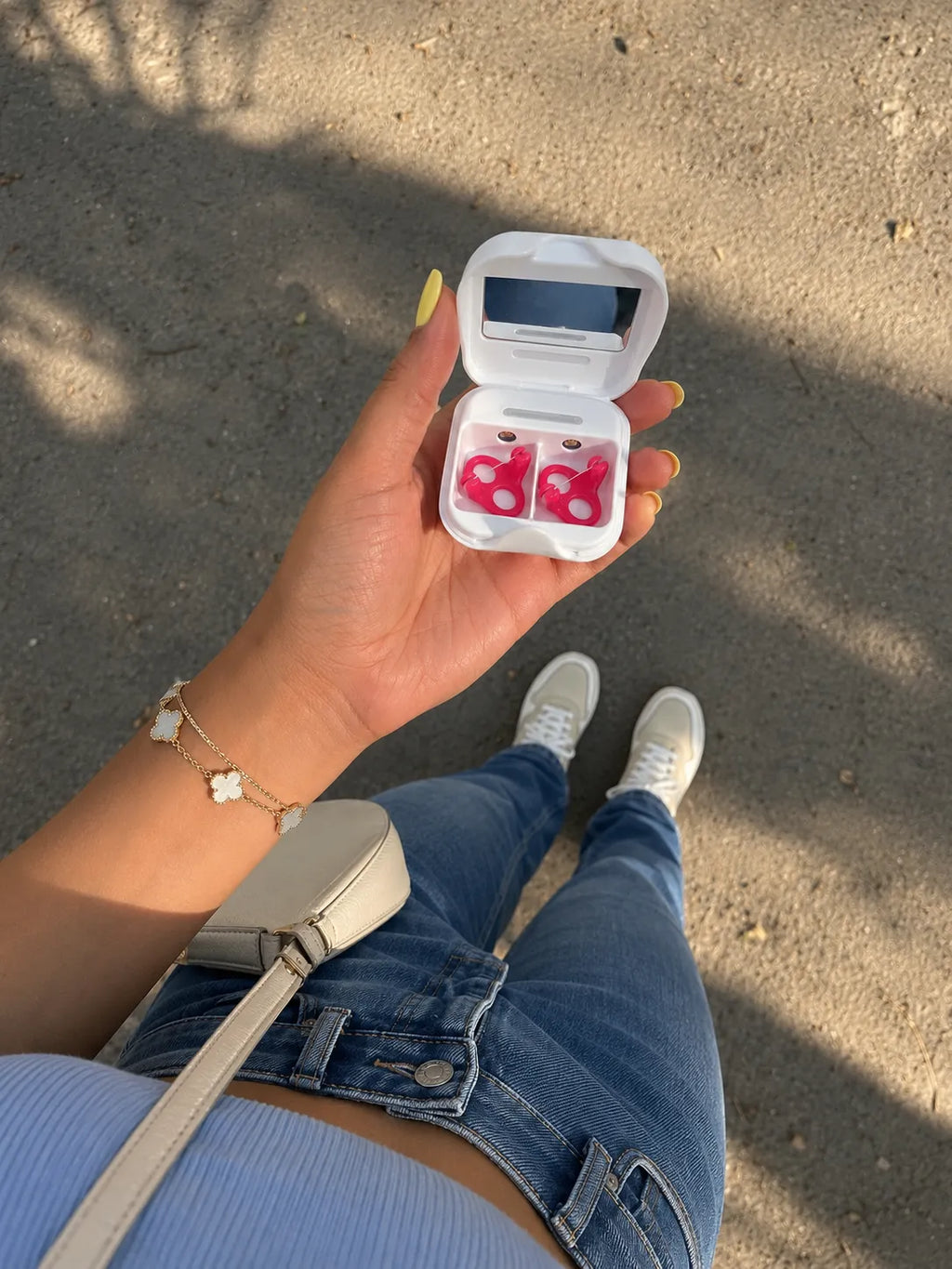 Person holding a Gfloss UV-C travel case with hands-free dental floss for on-the-go oral care.
